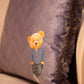 Herringbone decorative pillow with teddy bear motif