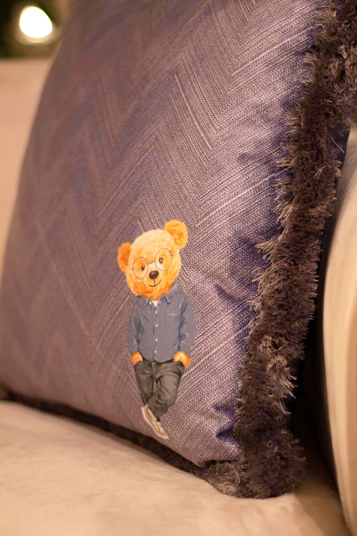 Herringbone decorative pillow with teddy bear motif
